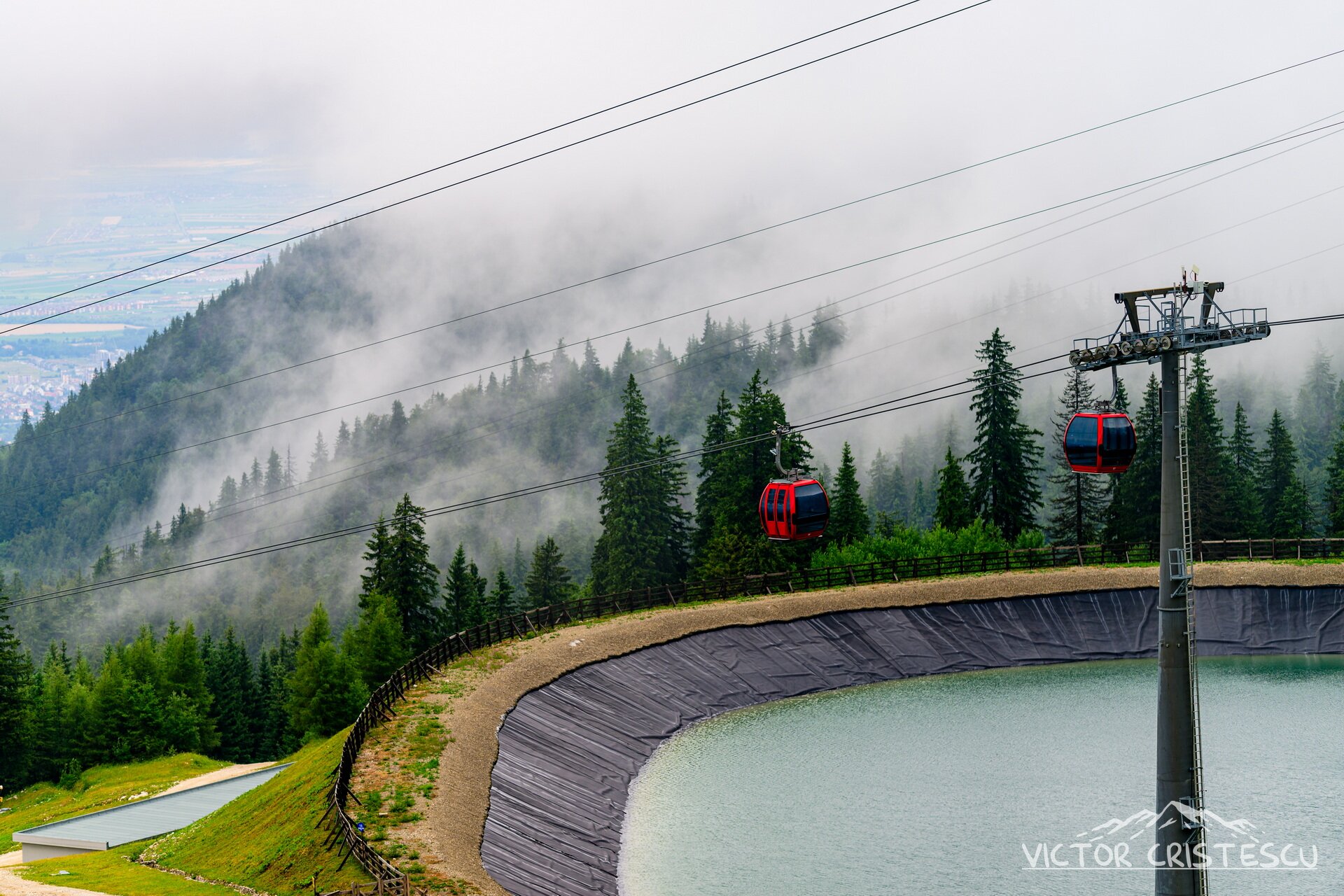 The Poiana Brașov gondola gliding through mist above the Ruia artificial lake
